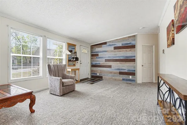 an empty room with fireplace and fan