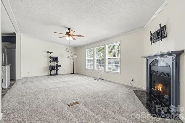 a view of a livingroom with furniture and a ceiling fan