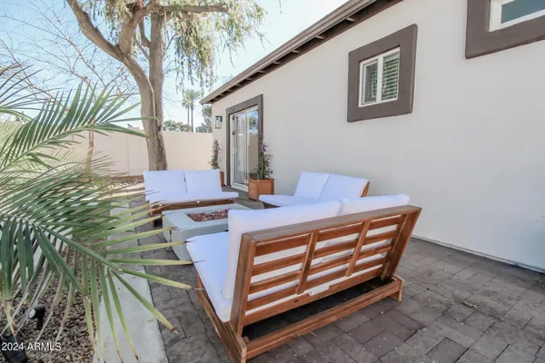 a view of a patio with table and chairs with wooden floor and fence
