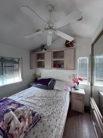 a bedroom with a large bed and a window