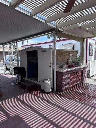 a view of a porch with furniture and a yard