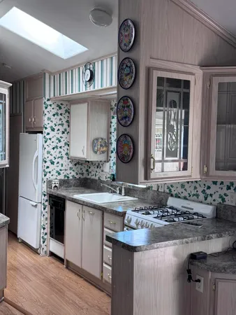 a kitchen with a sink and a stove top oven