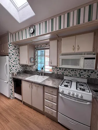 a kitchen with granite countertop a stove and a sink