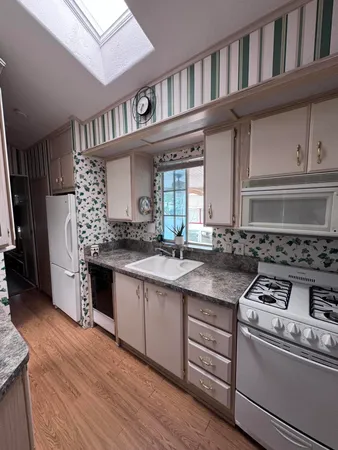 a kitchen with stainless steel appliances granite countertop a stove and a cabinets