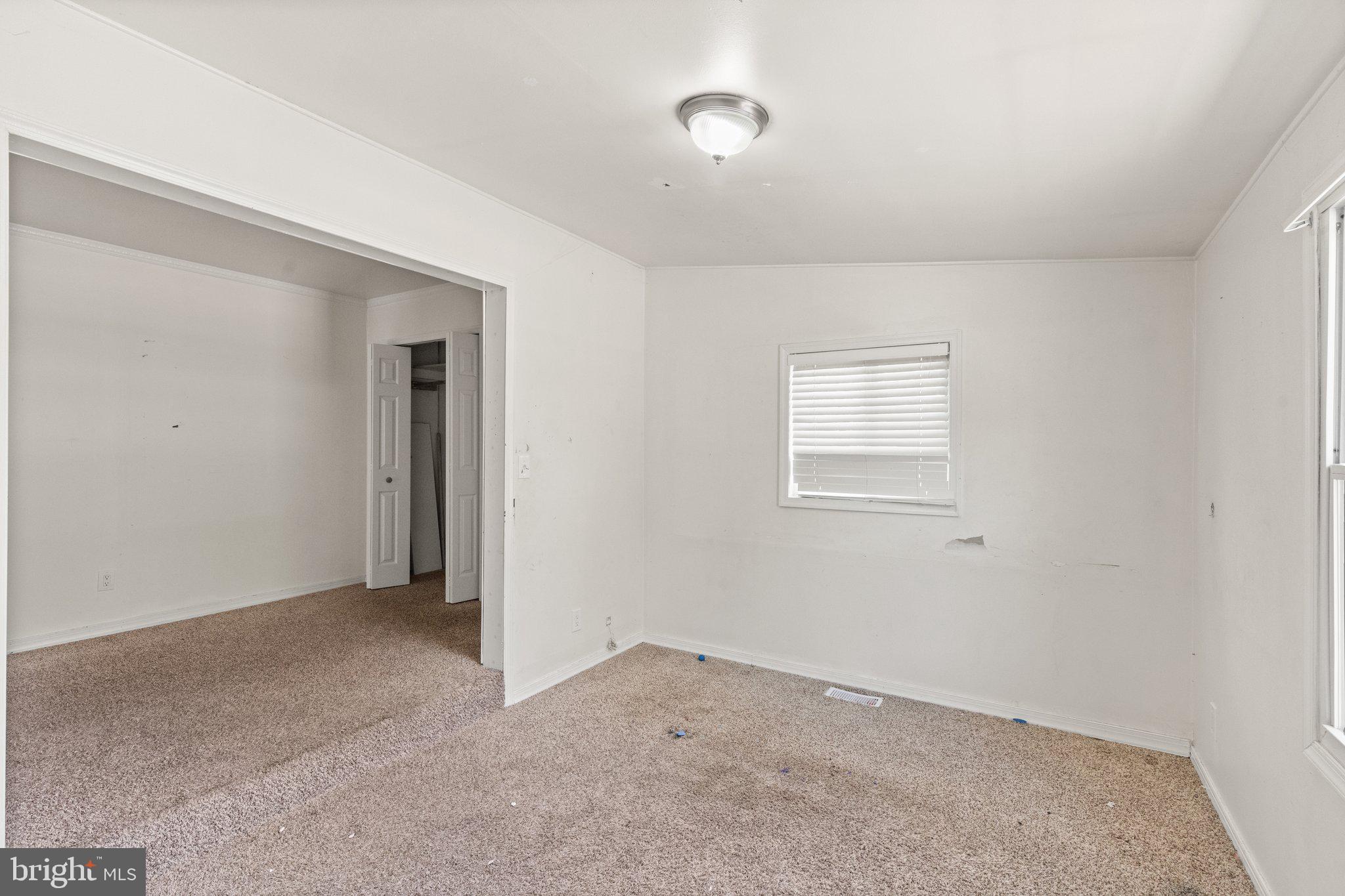 1047 Bowleys Quarters Road Middle River, MD 21220 - Photo 20 of 38 a view of an empty room with closet and a window