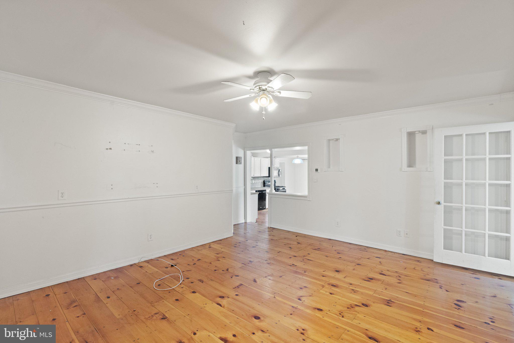 1047 Bowleys Quarters Road Middle River, MD 21220 - Photo 24 of 38 a view of empty room with wooden floor and ceiling fan