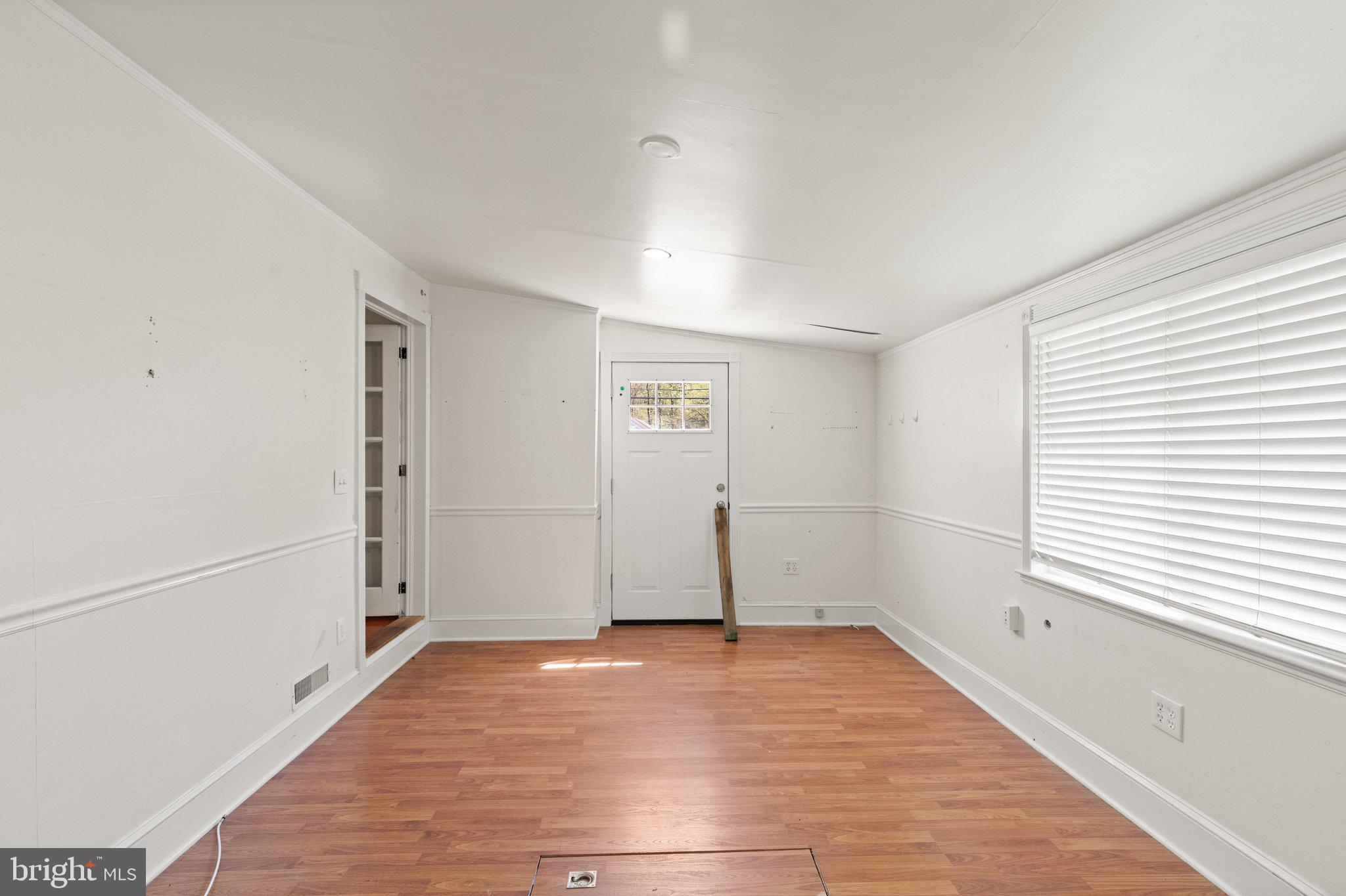 1047 Bowleys Quarters Road Middle River, MD 21220 - Photo 26 of 38 a view of empty room with wooden floor and fan