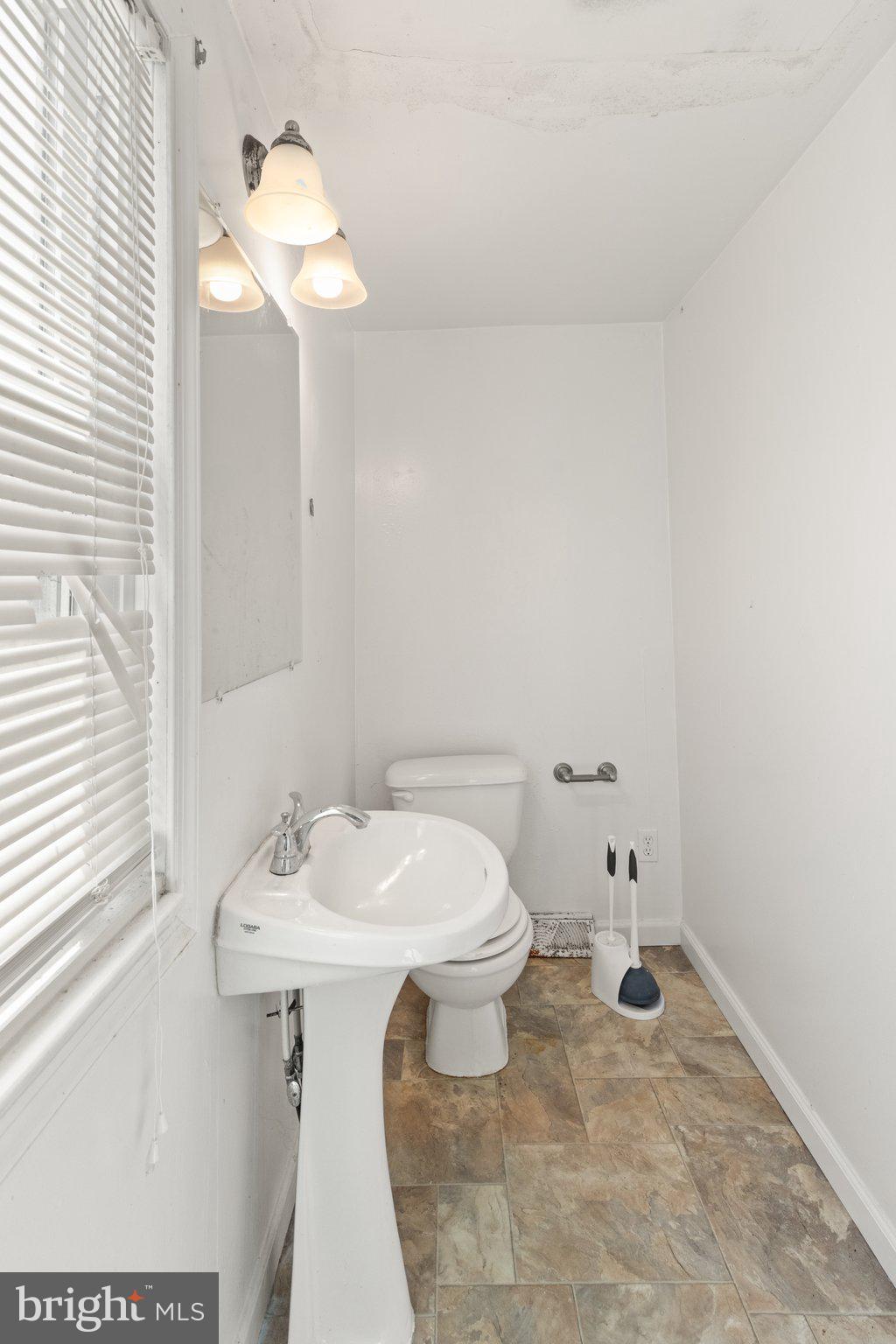 1047 Bowleys Quarters Road Middle River, MD 21220 - Photo 29 of 38 a bathroom with a sink a toilet and a mirror