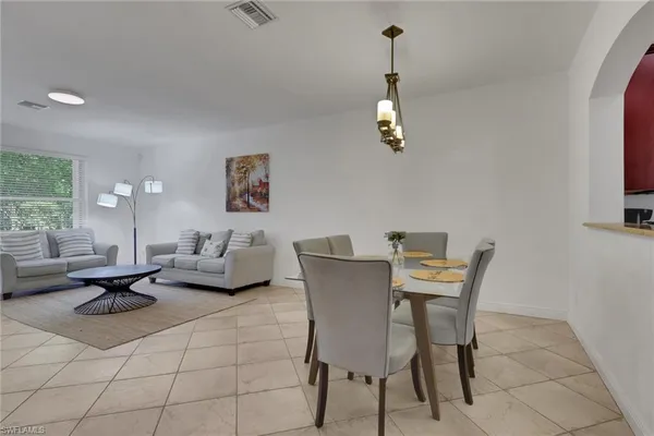 a dining room with furniture and window