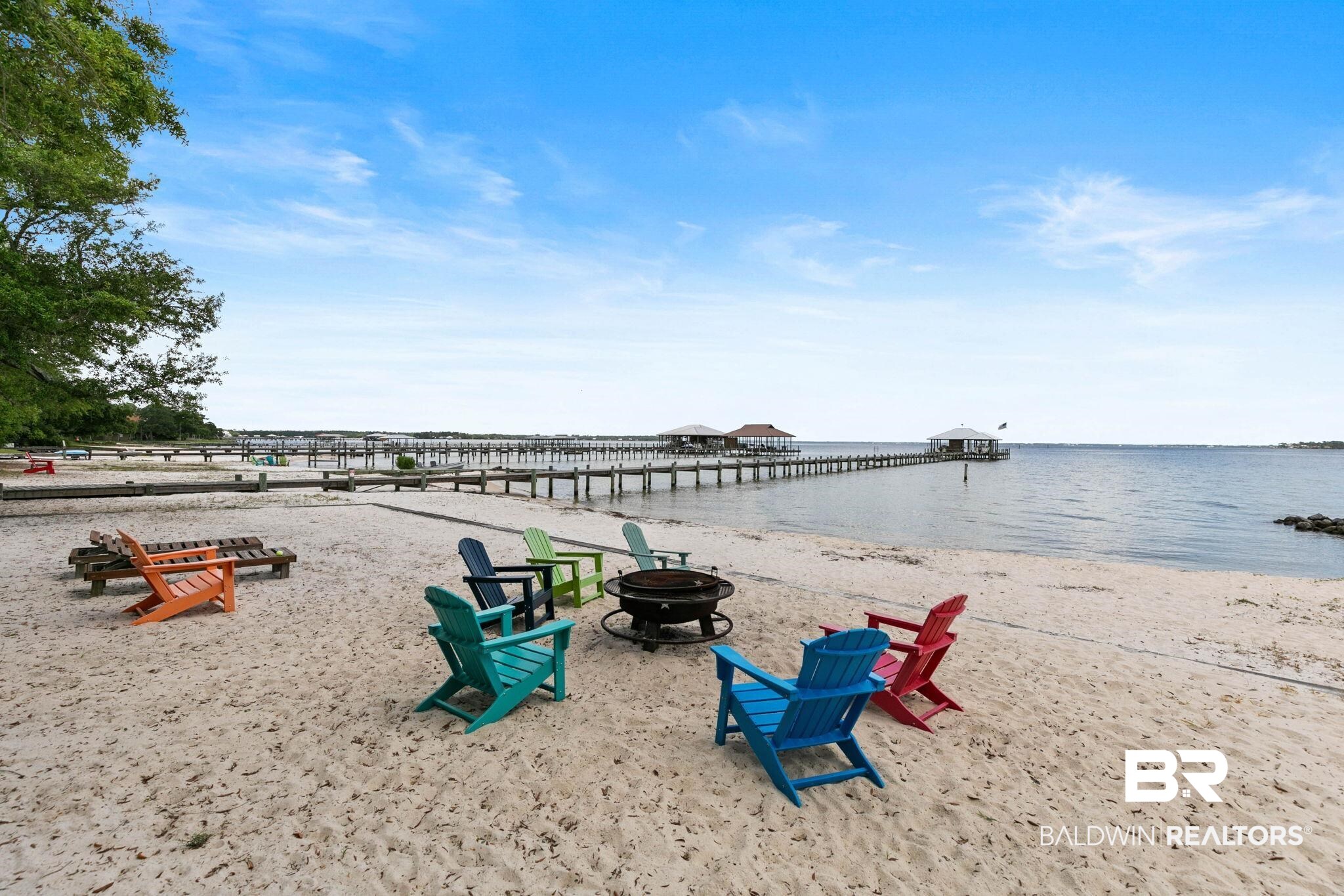 6802 Shore Drive Elberta, AL 36530 - Photo 28 of 34 Private sandy beach with a fire pit, multiple Adirondack chairs, and a long pier extending into the water