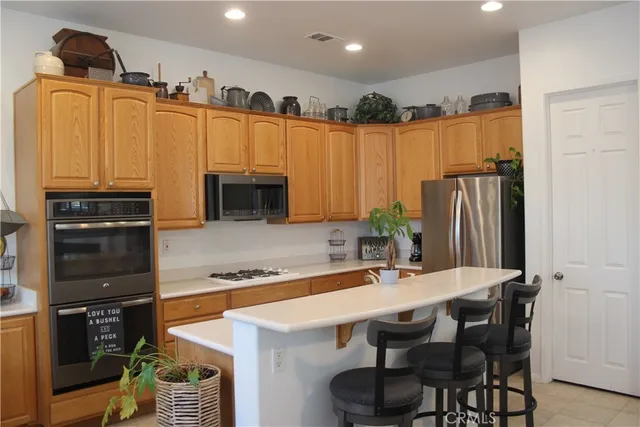 a kitchen with granite countertop a sink cabinets and stainless steel appliances
