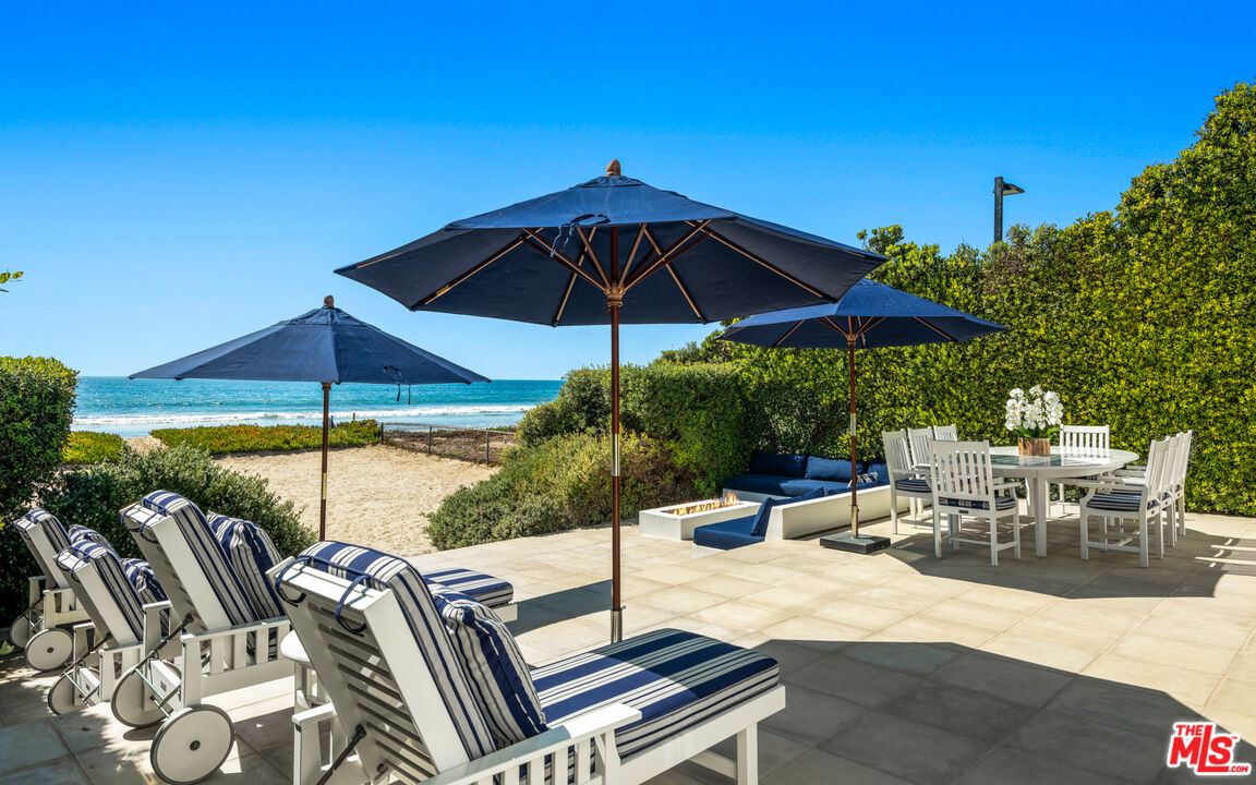 31240 Broad Beach Road Malibu, CA 90265 - Photo 11 of 54 a view of an outdoor sitting area with chairs and umbrella