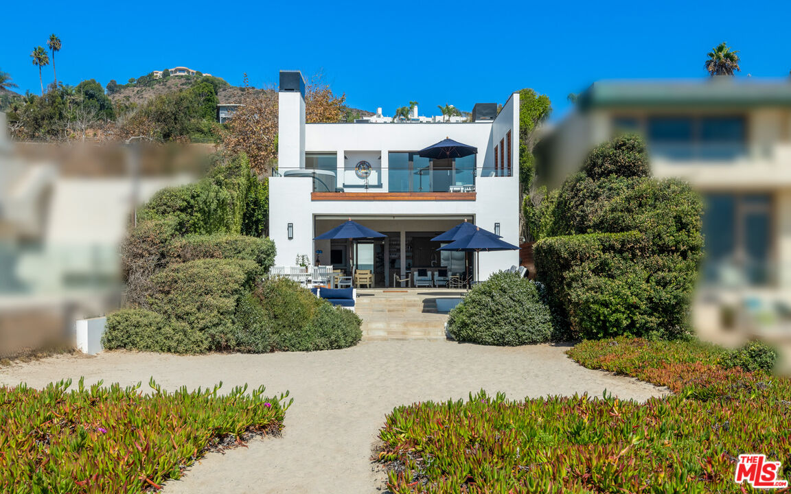 31240 Broad Beach Road Malibu, CA 90265 - Photo 18 of 54 a front view of a house with a yard