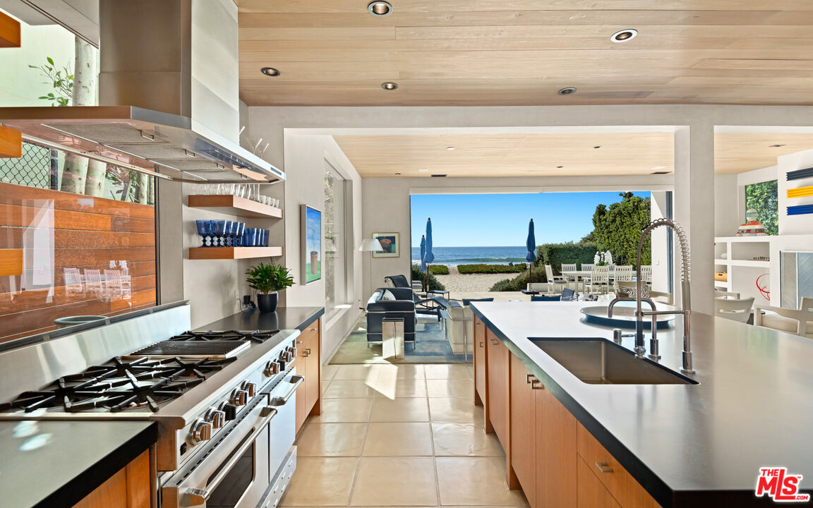 31240 Broad Beach Road Malibu, CA 90265 - Photo 21 of 54 a kitchen with lots of counter top space and wooden floor