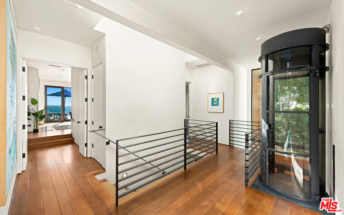 31240 Broad Beach Road Malibu, CA 90265 - Photo 23 of 54 a view of a hallway with wooden floor and windows
