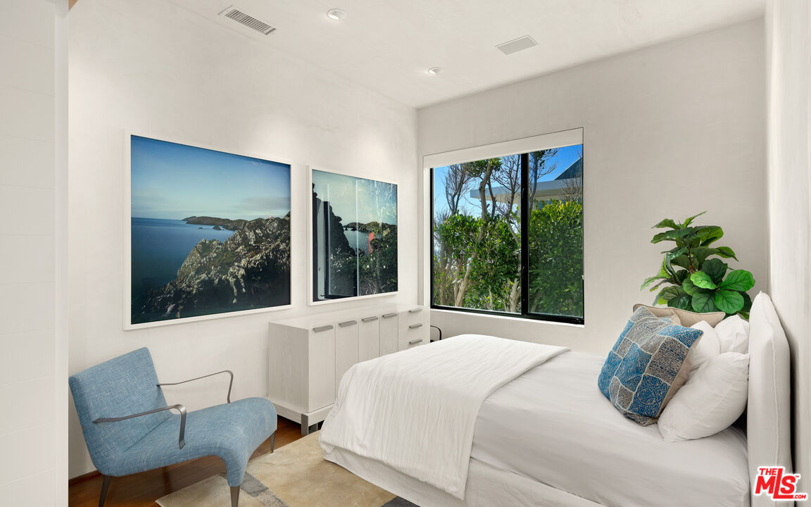 31240 Broad Beach Road Malibu, CA 90265 - Photo 35 of 54 a bedroom with a bed and a chair