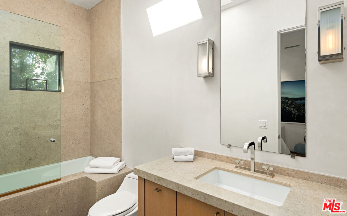 31240 Broad Beach Road Malibu, CA 90265 - Photo 36 of 54 a bathroom with a granite countertop sink mirror and toilet