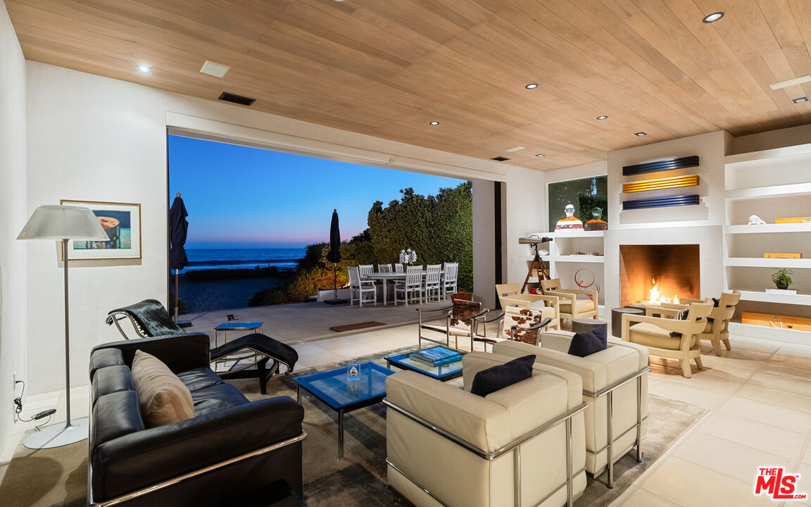 31240 Broad Beach Road Malibu, CA 90265 - Photo 48 of 54 a living room with furniture a rug and a fireplace
