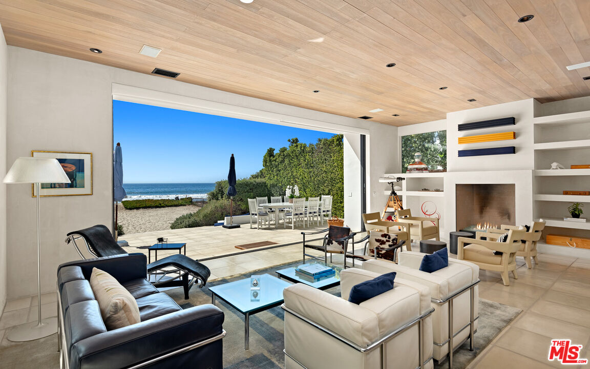 31240 Broad Beach Road Malibu, CA 90265 - Photo 8 of 54 a living room with fireplace furniture and a large window