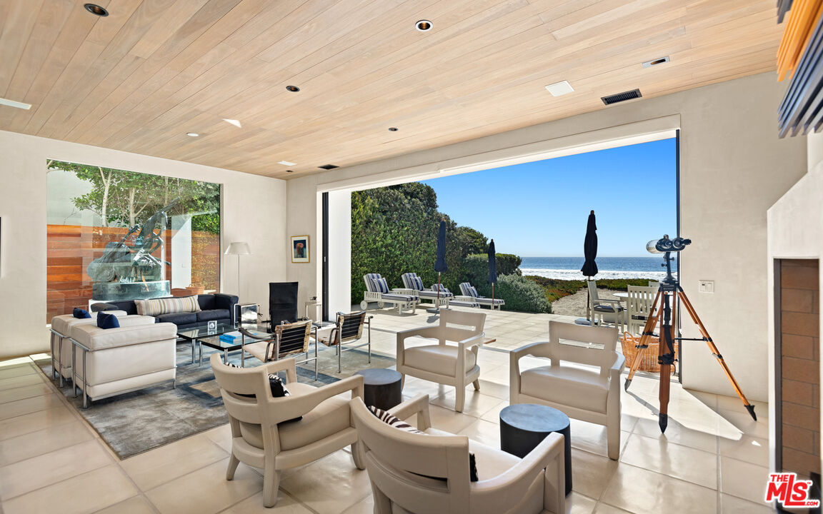 31240 Broad Beach Road Malibu, CA 90265 - Photo 9 of 54 a living room with fireplace furniture and a large window