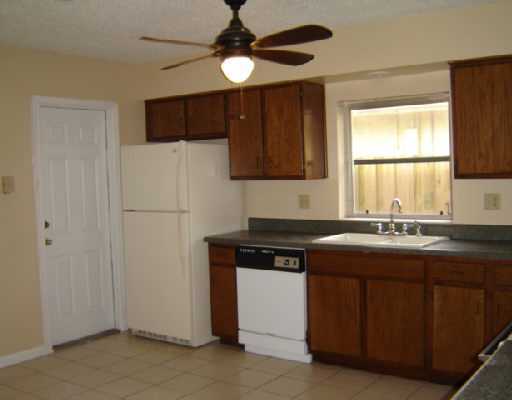 a kitchen with a sink stove and refrigerator