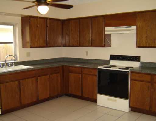5551 Northwest 5th Avenue Boca Raton, FL 33487 - Photo 2 of 5 a kitchen with granite countertop a sink and a stove