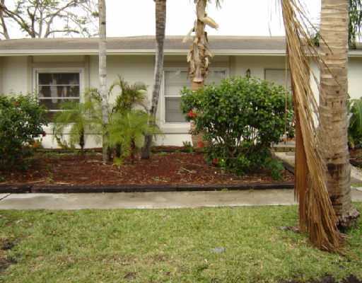 5551 Northwest 5th Avenue Boca Raton, FL 33487 - Photo 5 of 5 a front view of a house with garden