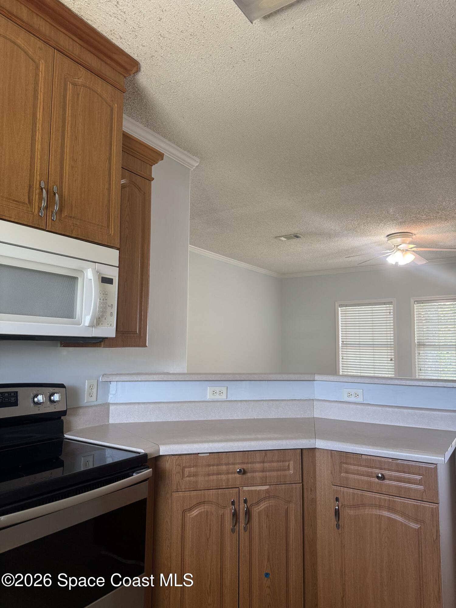 1130 Grapefruit Road Southeast Palm Bay, FL 32909 - Photo 6 of 14 a kitchen with a sink and cabinets