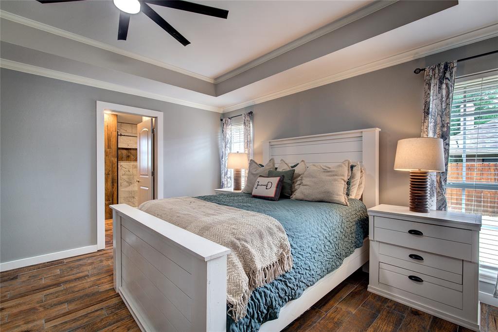 2027 Park Springs Road Sulphur Springs, TX 75482 - Photo 20 of 39 a bedroom with a bed and a lamp on dresser
