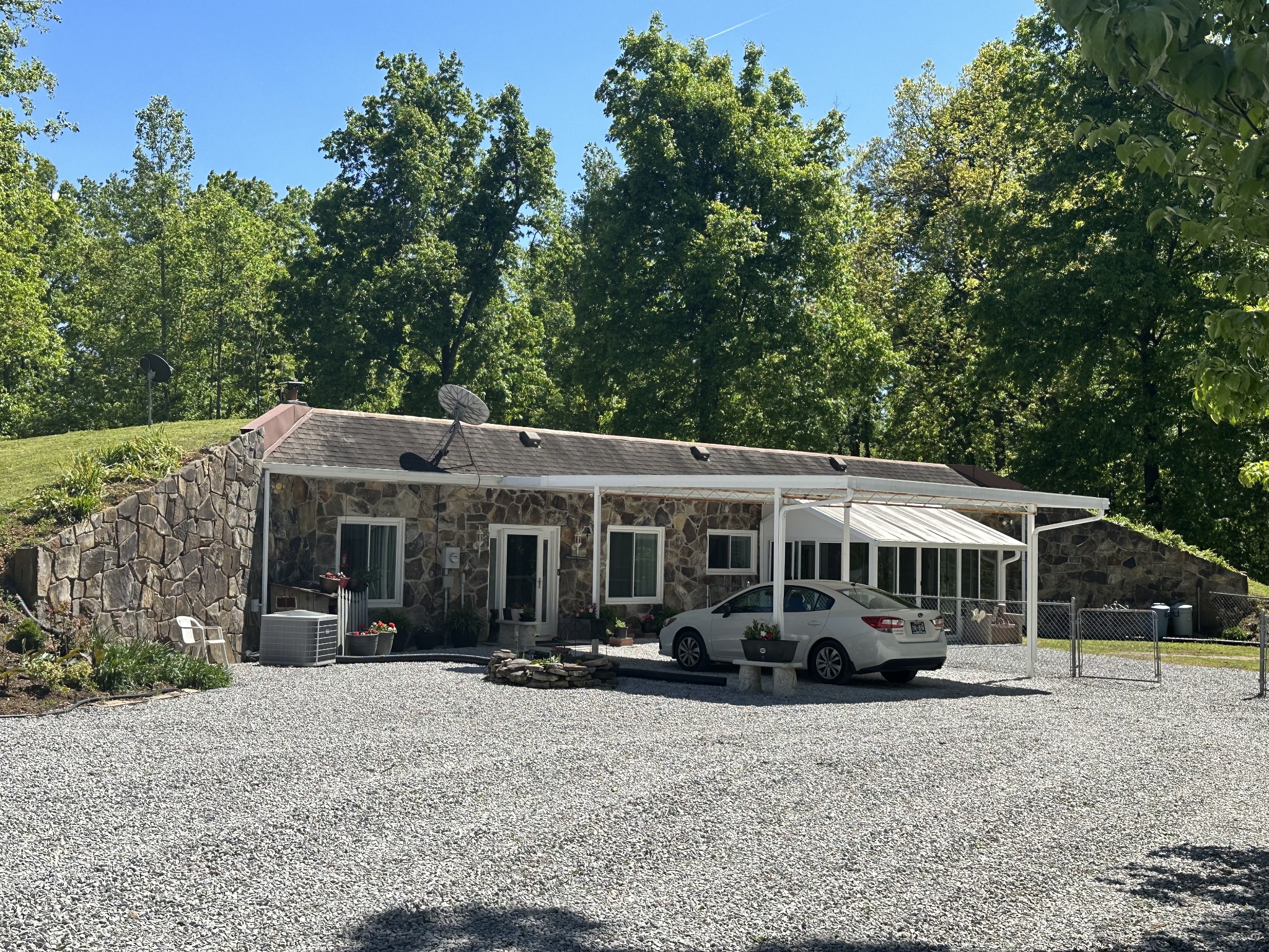 a front view of a house with a garden and trees