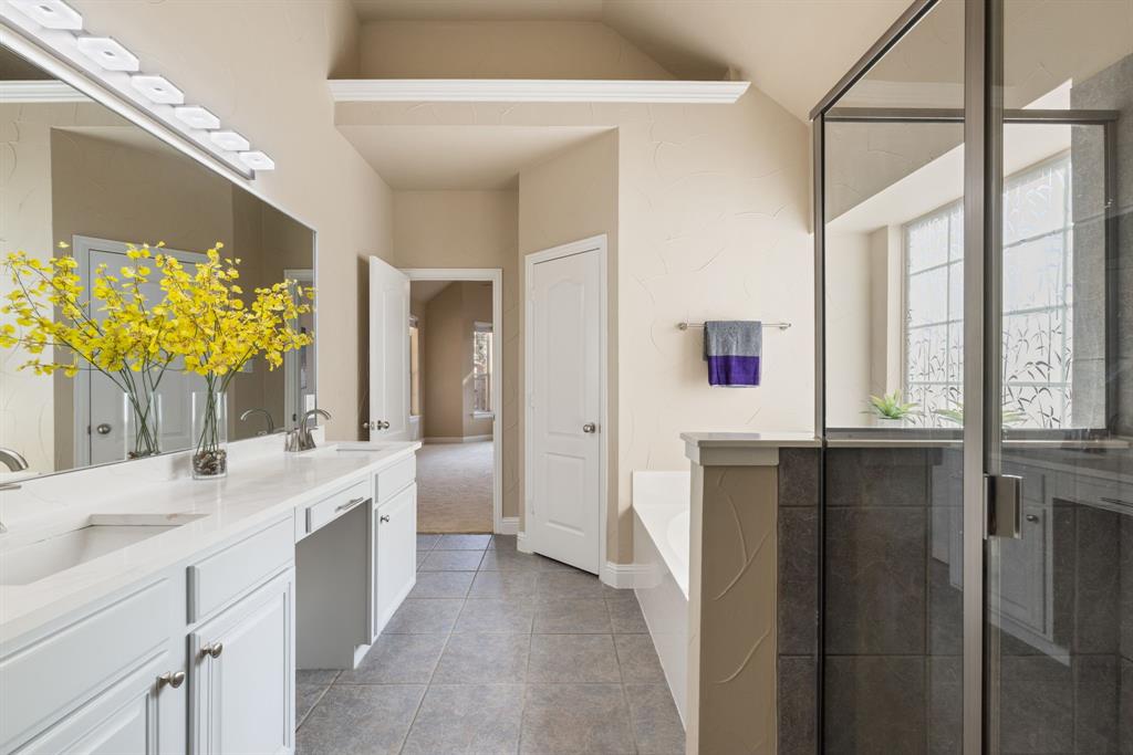2475 Brazos Drive Frisco, TX 75033 - Photo 19 of 34 a bathroom with a double vanity sink a mirror and a bathtub