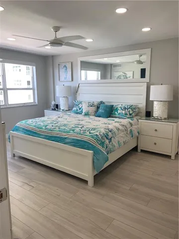 a spacious bedroom with a bed and a dresser