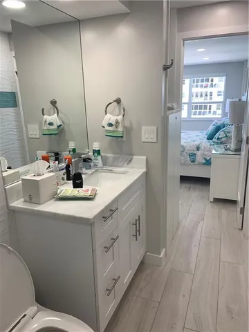 a bathroom with a sink a toilet and a mirror