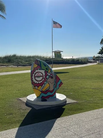 a view of a balcony with wooden floor chairs and a potted plant