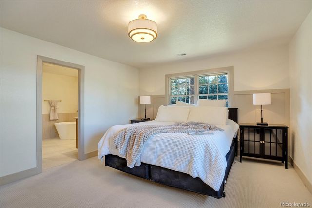 a spacious bedroom with a bed and a window