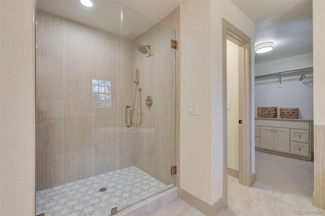 a bathroom with a shower sink and mirror