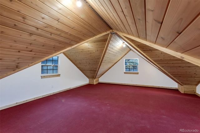 a view of a balcony with wooden floor and fence