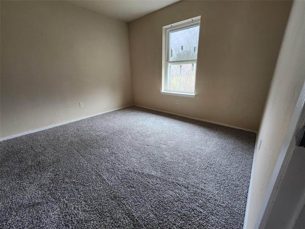 4304 South Cravens Road Fort Worth, TX 76119 - Photo 12 of 21 Empty room with carpet