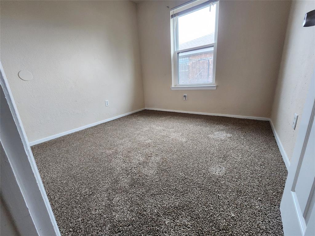 4304 South Cravens Road Fort Worth, TX 76119 - Photo 14 of 21 Empty room featuring carpet floors