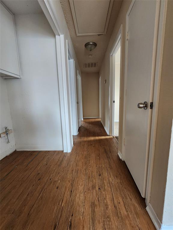4304 South Cravens Road Fort Worth, TX 76119 - Photo 16 of 21 Hallway featuring hardwood / wood-style floors