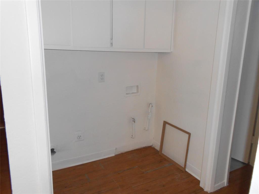 4304 South Cravens Road Fort Worth, TX 76119 - Photo 21 of 21 Washroom with dark wood-type flooring, cabinets, and electric dryer hookup