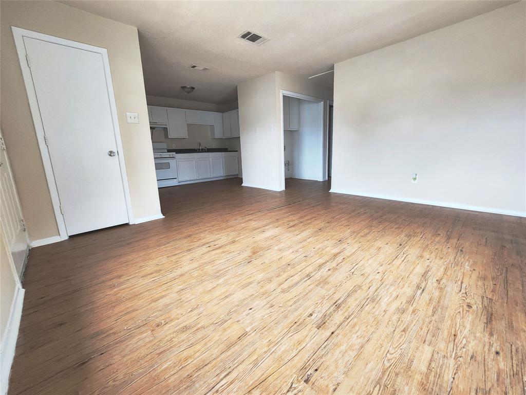 4304 South Cravens Road Fort Worth, TX 76119 - Photo 9 of 21 Unfurnished living room featuring sink and light hardwood / wood-style floors