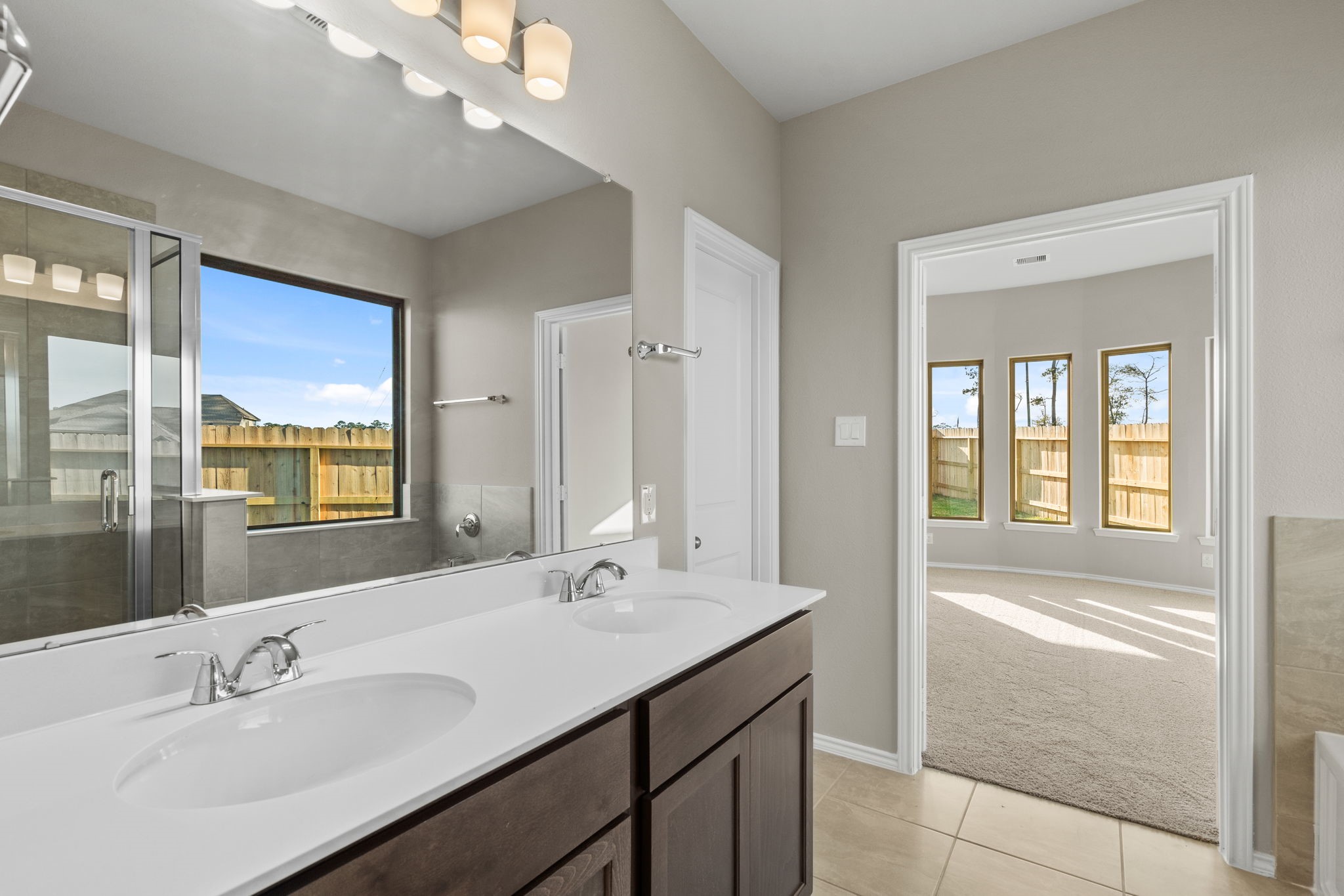 32027 Retama Rnch Drive Spring, TX 77386 - Photo 19 of 33 a bathroom with a sink double vanity and a mirror