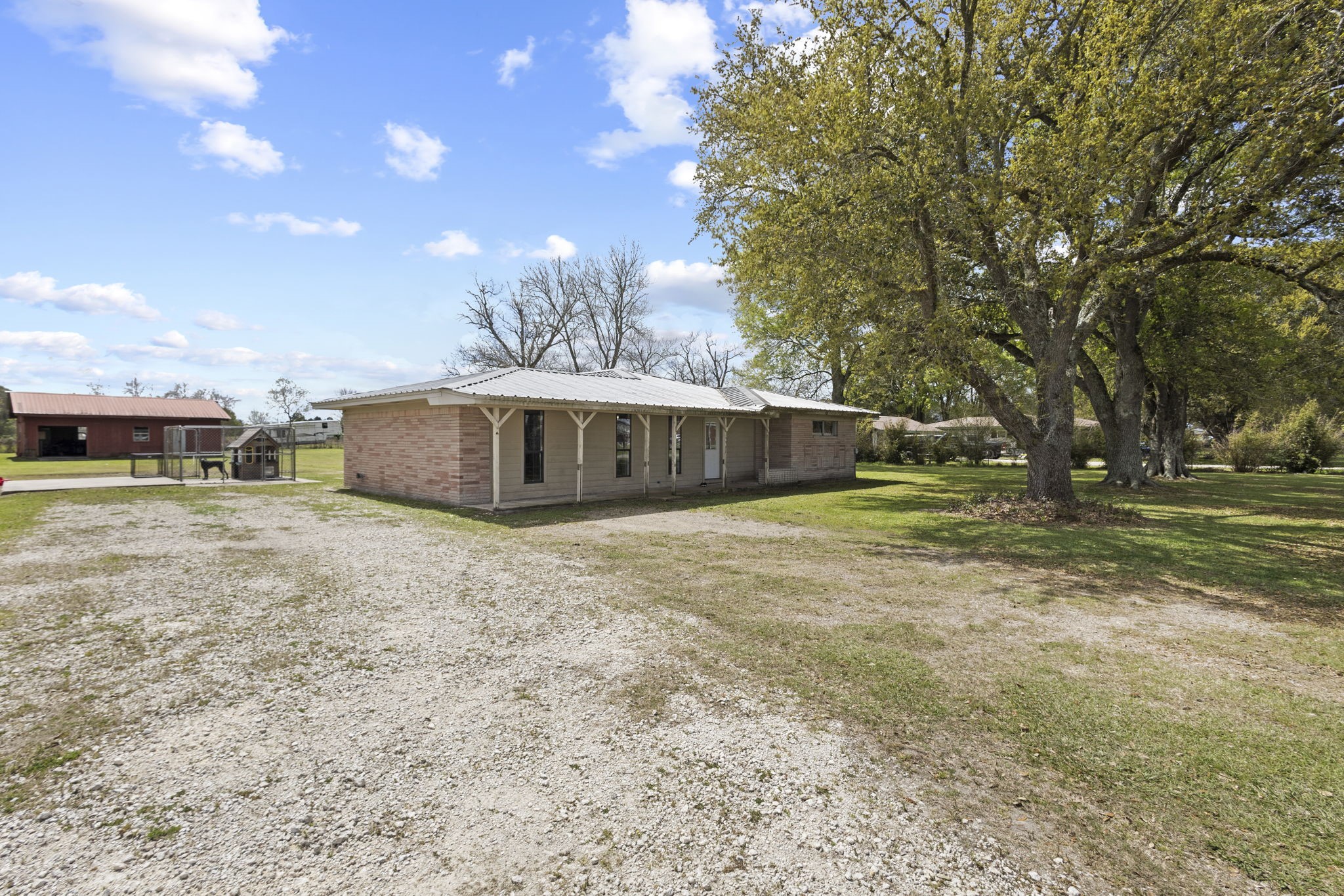 19961 Englin Road Winnie, TX 77665 - Photo 4 of 26 a front view of a house with a yard