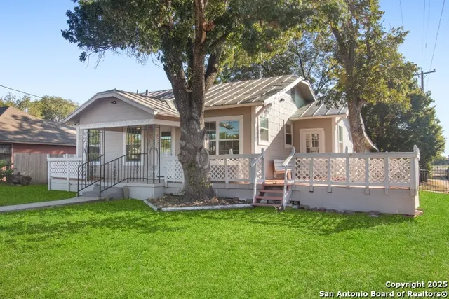 a front view of a house with a garden and yard