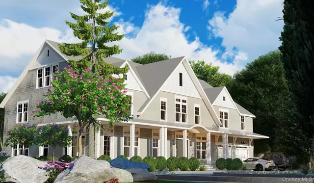 a view of a white house with a yard and potted plants