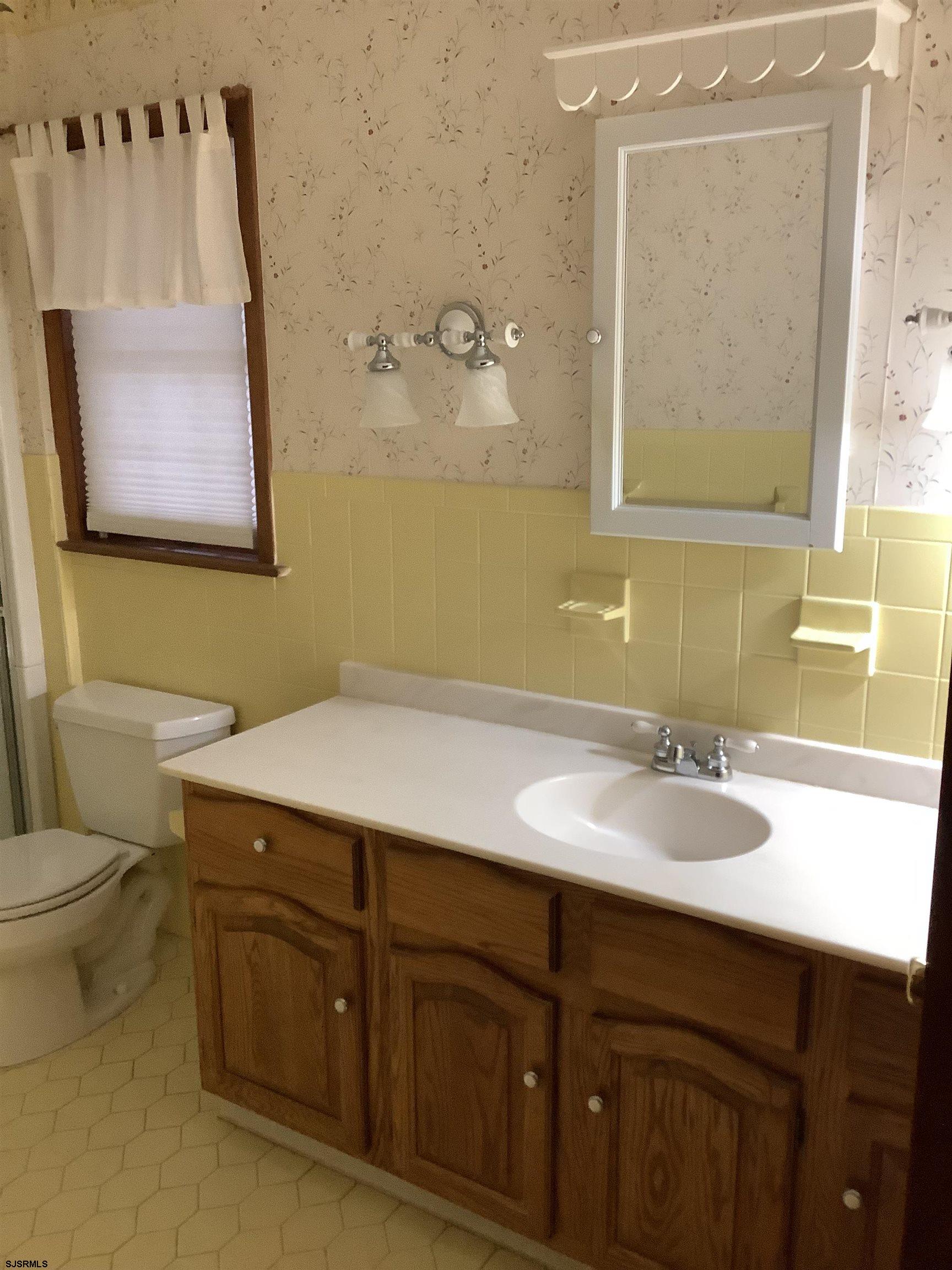 145 Allendale Road Marmora, NJ 08223 - Photo 20 of 27 a bathroom with a granite countertop sink a mirror and a toilet