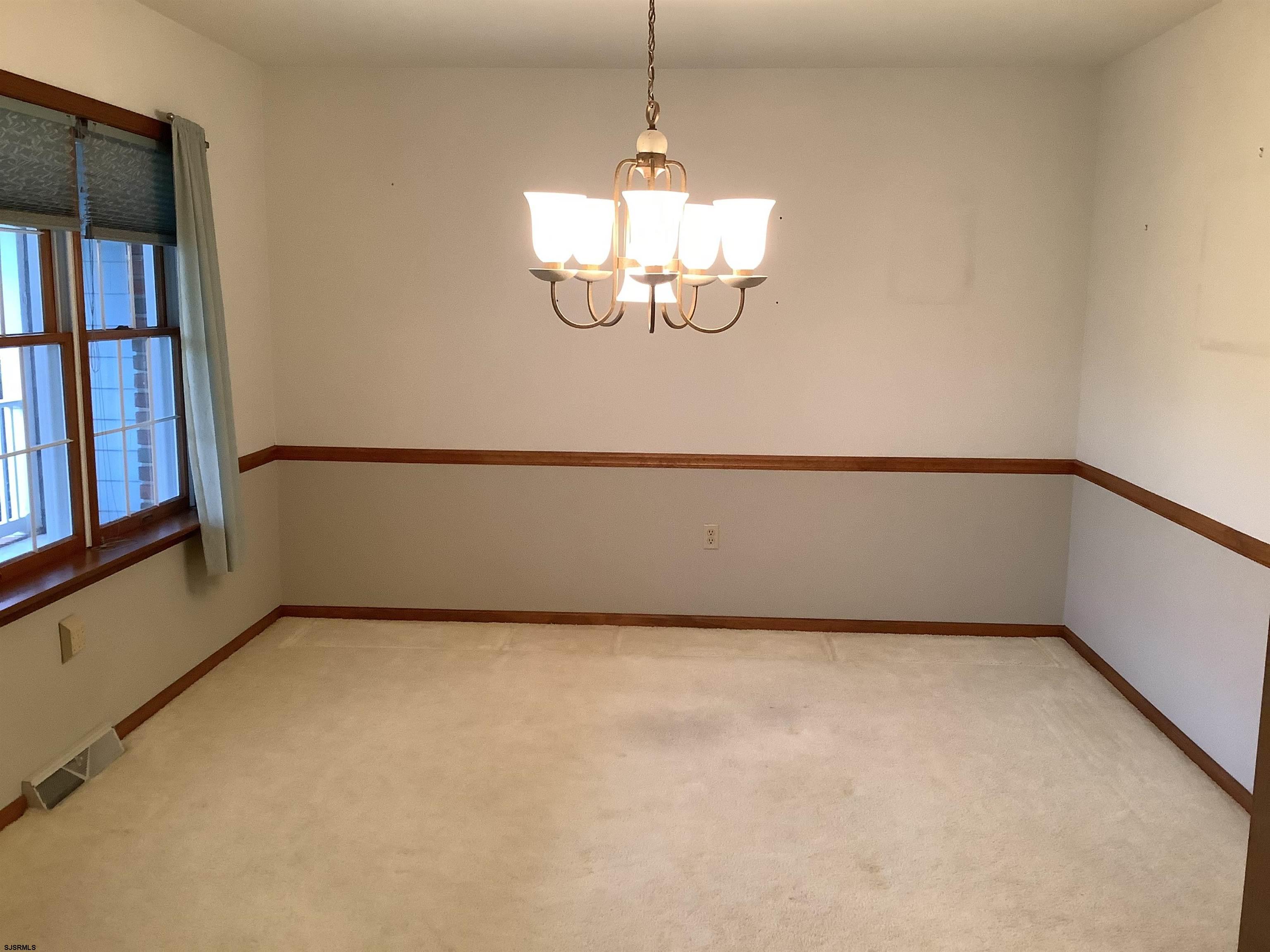 145 Allendale Road Marmora, NJ 08223 - Photo 7 of 27 a view of a big room with chandelier fan and windows