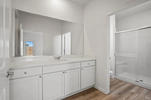 a bathroom with a double vanity sink and mirror