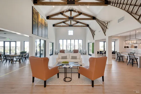 a living room with furniture and a chandelier